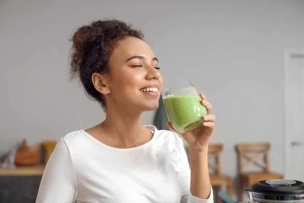 Young woman drinking fresh smoothie