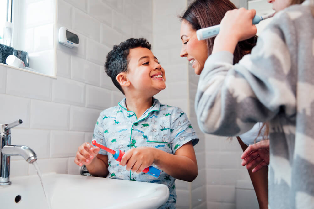 Children are brushing their teeth in the bathroom
