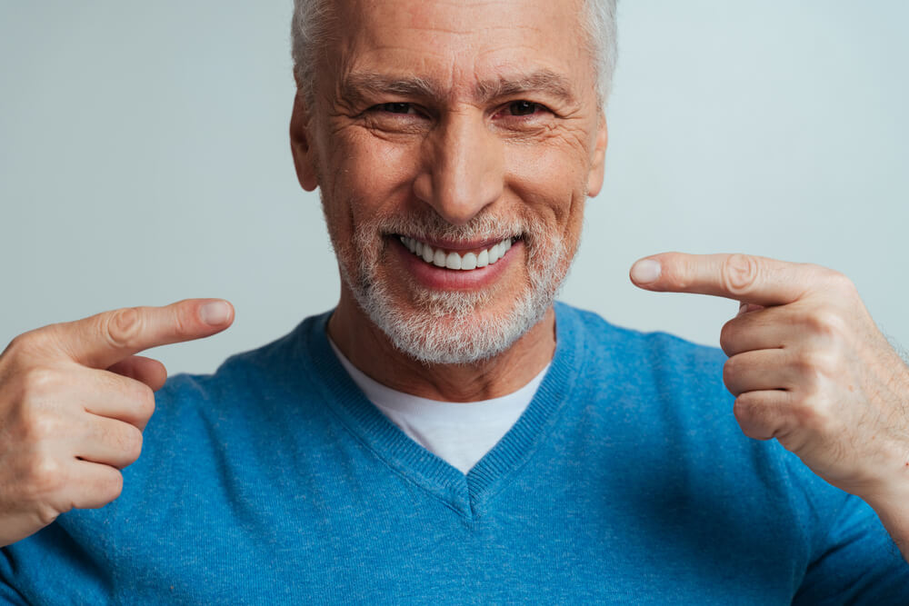 Handsome senior isolated on grey background